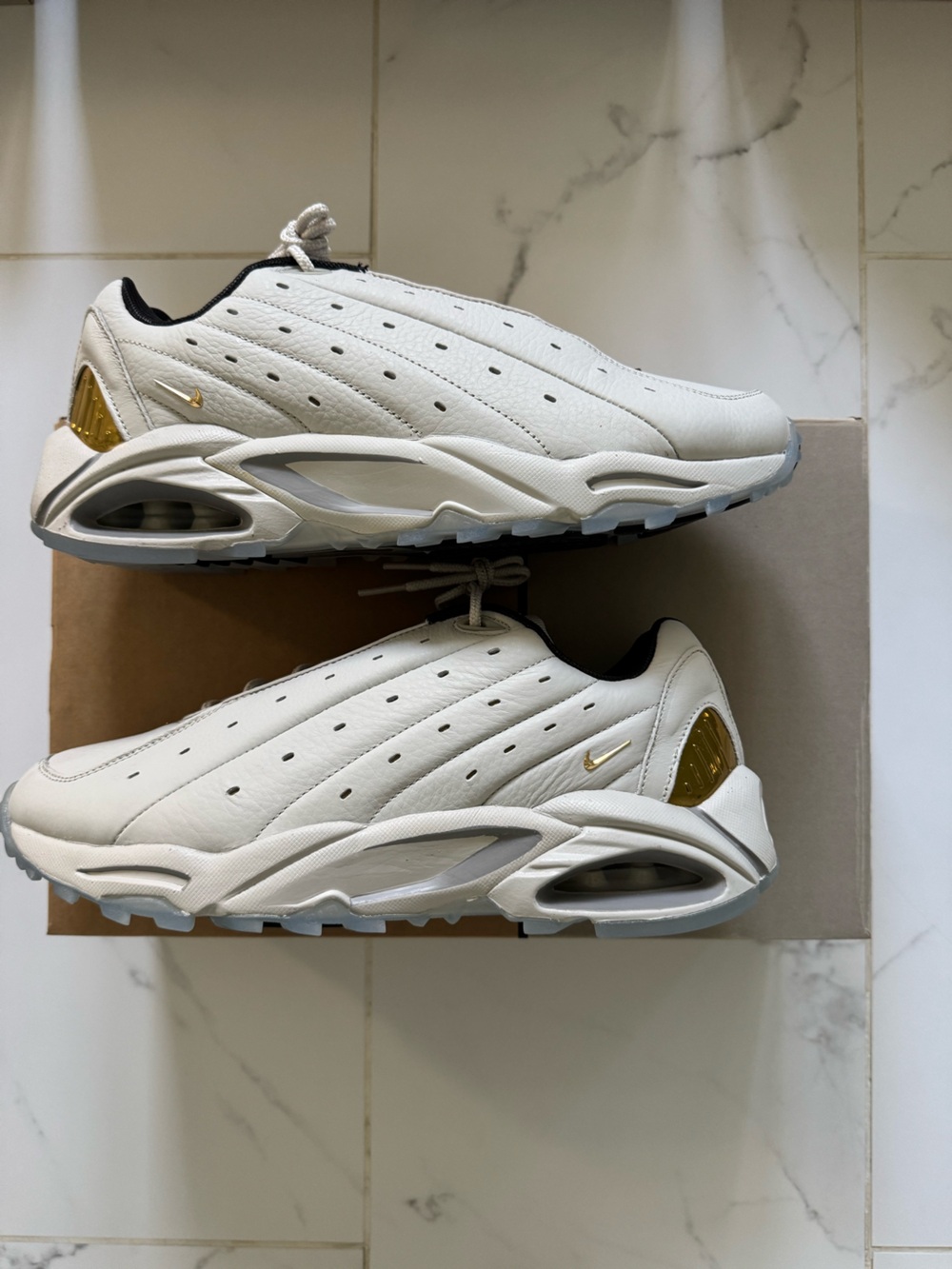 NOCTA x Nike Men’s White Leather Sneakers with Gold Accents